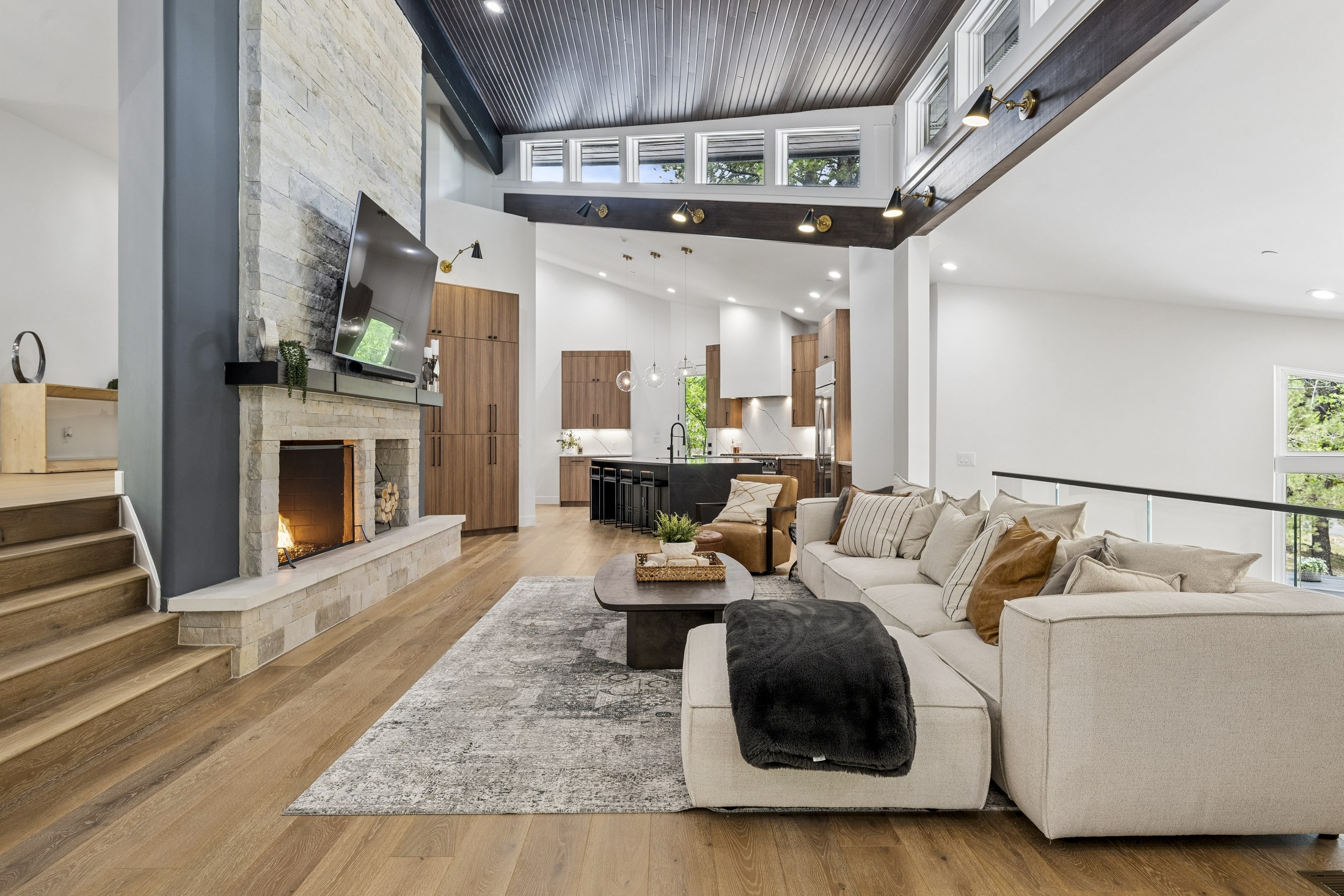Dramatic vaulted living room connected to the relocated kitchen
