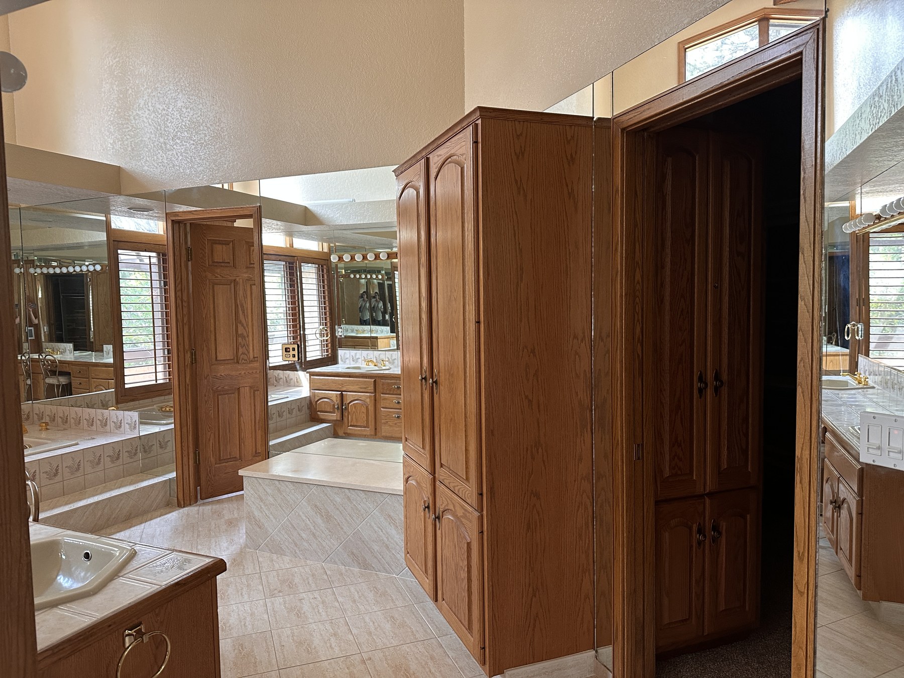 Before · Original Primary Bathroom — mirrors and back wall limited the view of the old shower